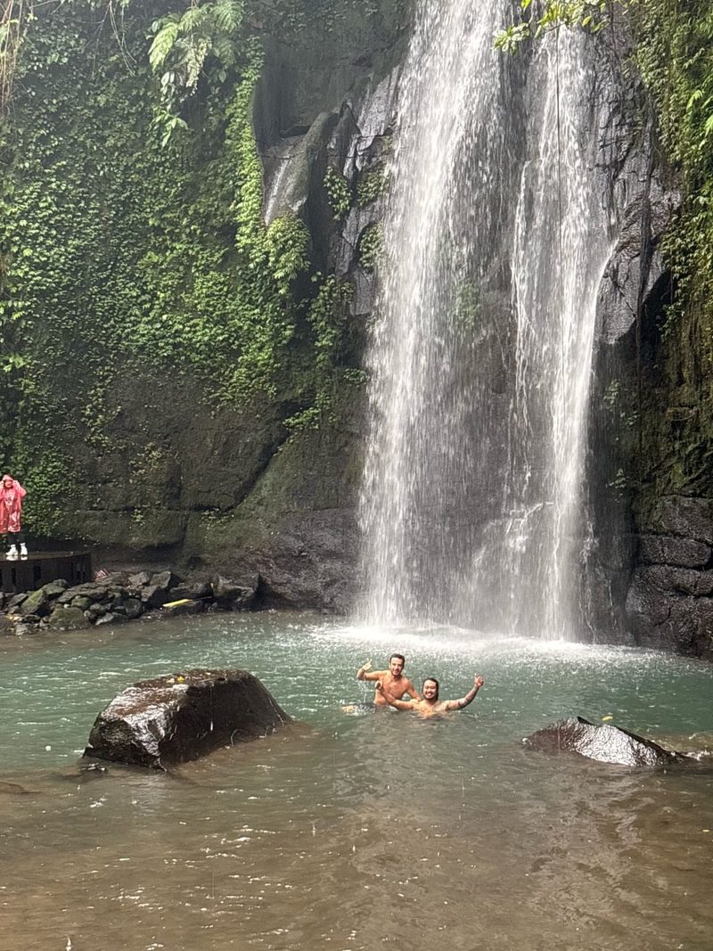 Ari with tourist at Bali waterfall